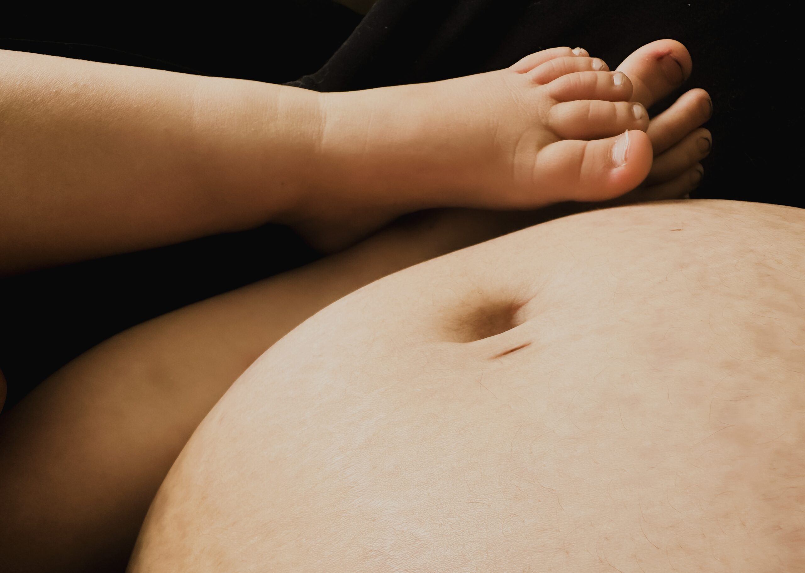 pregnant belly and toddler on lap