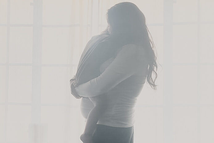 pregnant mom holding baby